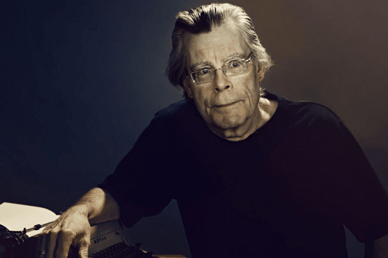 Headshot of Stephen King leaning on a typewriter